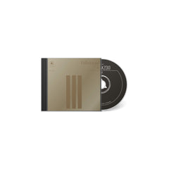 III album CD by Follakzoid with minimalist gold and black cover design and black disc labeled with title