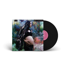 Black vinyl record partially out of the sleeve featuring a pregnant woman on the cover for Sounds of the Unborn vinyl.