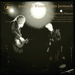 Two musicians playing guitar on stage under bright spotlights for The Mystery of Heaven vinyl release