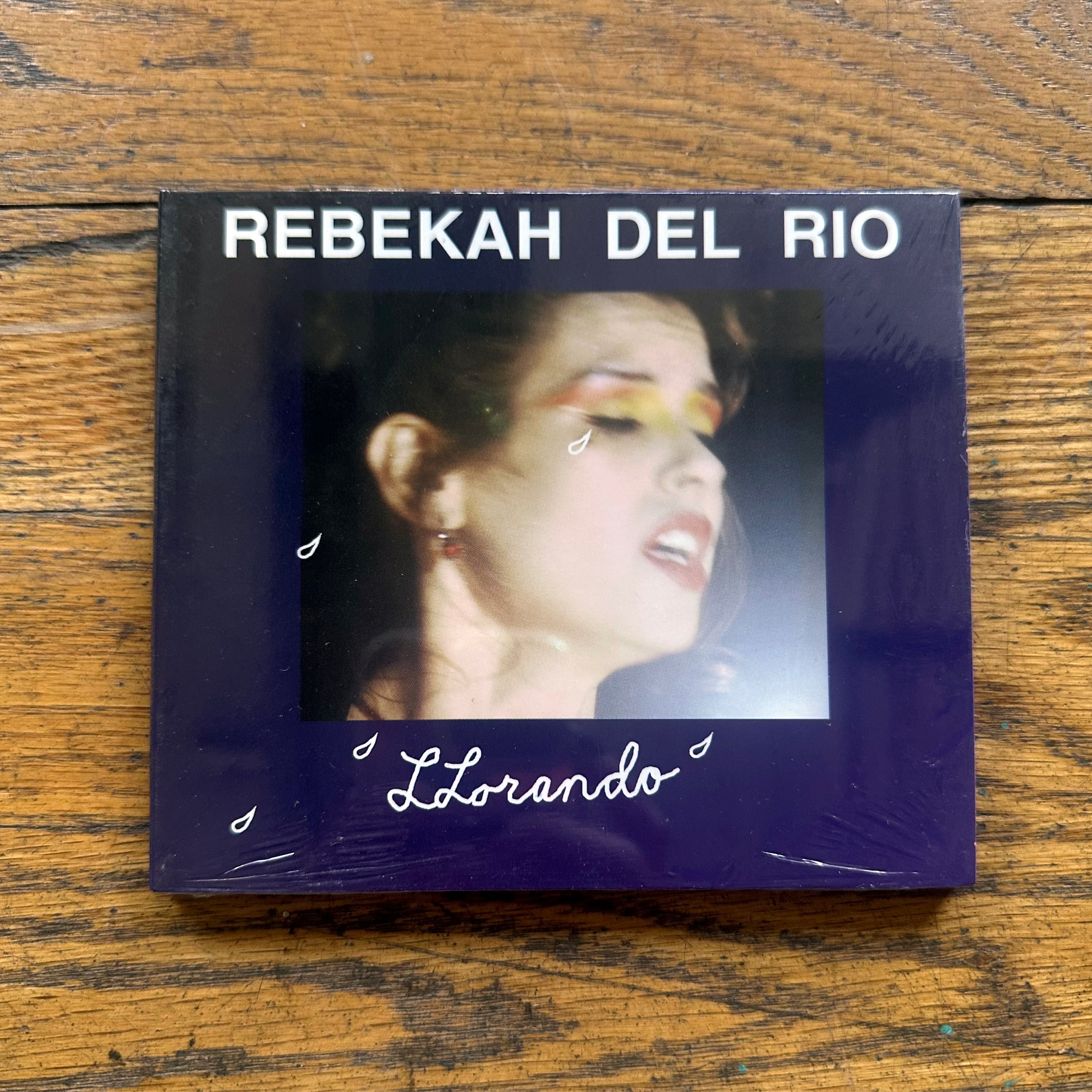 Rebekah Del Rio: Llorandro CD cover with close-up of singer's face and artistic tears on dark blue background.