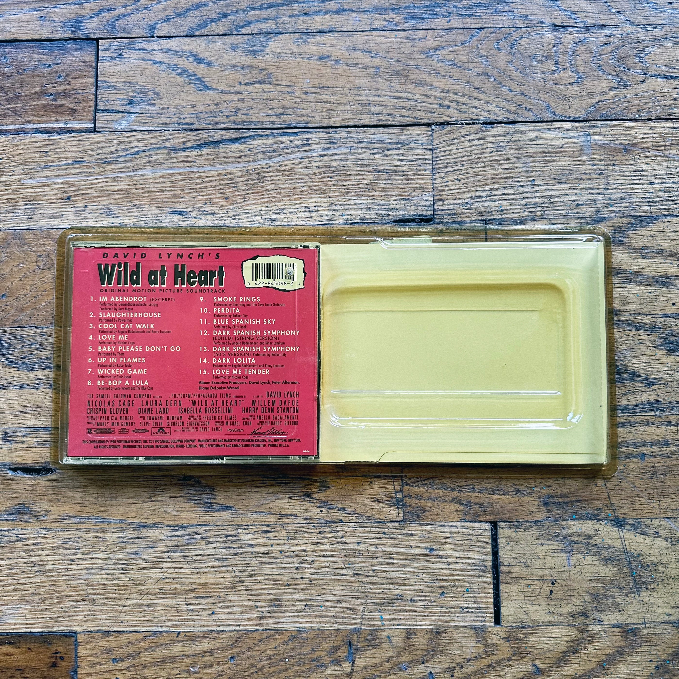 Wild At Heart Long Box CD showing back cover with tracklist on wooden surface in clear case