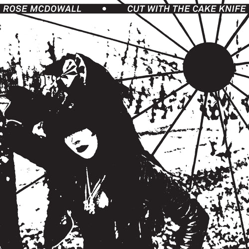 Black and white artistic image of a woman in dark attire under a sun with rays, titled Cut With the Cake Knife.